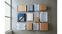 Modern office organization system with colorful storage boxes and containers arranged on gray wall for workspace efficiency and decluttering solutions.