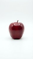 Fresh red apple isolated on white background, ready for food and nutrition design projects, healthy eating concepts, and culinary applications.