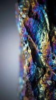 Iridescent rainbow metallic surface with vibrant purple blue gold reflections creating abstract textured background for modern design projects.