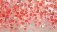 Delicate coral pink paper hearts hanging on thin strings create romantic atmosphere with soft bokeh effect and dreamy blurred background. Suitable for wedding designs.