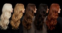 Collection of five long wavy hair wigs in different colors from platinum blonde to auburn red displayed in profile view on black background for beauty salon.