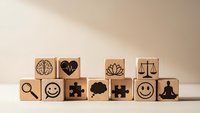 Wooden blocks with mental health and wellness symbols arranged on neutral background for mindfulness and psychological wellbeing concepts.