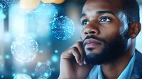 Young African American businessman in deep thought against blue bokeh background with glowing digital spheres representing global connectivity and future technology.