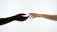Two hands reaching toward each other against white background symbolizing connection, unity, help, support, teamwork, cooperation and human relationships.