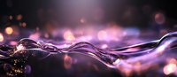 Flowing liquid wave with purple and pink bokeh lights creating magical atmosphere against dark background, abstract macro photography.