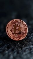 Copper-colored cryptocurrency coin with detailed circuit pattern design on dark textured background, dramatic lighting highlights metallic surface. Suitable for finance articles.