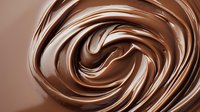 Swirling melted chocolate cream background with smooth glossy texture and rich brown spiral pattern creates appetizing dessert backdrop for food photography.
