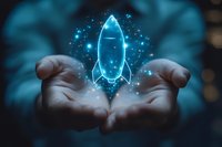 Glowing blue holographic rocket floating above open palms against dark background, sparkling particles create magical startup concept atmosphere.