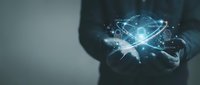 Businessman holding glowing digital atom with connected network nodes, representing quantum computing, artificial intelligence, and advanced technology innovation.