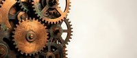 Vintage mechanical gears and cogs arrangement on neutral background for steampunk industrial design projects and clockwork mechanism concepts.