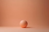 Single egg on a soft peach background with minimalist composition, copy space above for text, suitable for food, Easter, and lifestyle projects.