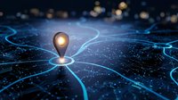 Glowing location pin on futuristic digital network map with blue circuit pathways and bokeh lights representing GPS navigation and connectivity technology.