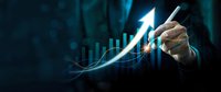 Businessman hand drawing upward arrow on financial growth chart with glowing digital data visualization for business success and investment analysis.