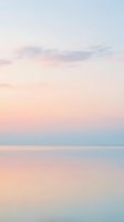 Serene twilight seascape with soft pastel sky reflecting on calm water, capturing peaceful dusk atmosphere for relaxation and wellness design projects.