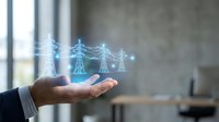 Businessman holding glowing holographic electric power transmission towers, symbolizing smart grid technology and energy management innovation.