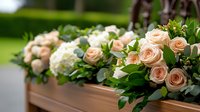 Elegant peach roses and white hydrangeas adorning wooden casket at outdoor funeral ceremony, with lush greenery and floral arrangement creating peaceful memorial atmosphere.