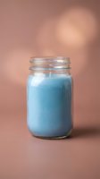 Blue smoothie or protein shake in glass mason jar on pink background for healthy lifestyle and nutrition concepts.