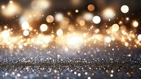 Magical golden bokeh lights and glitter sparkle on dark background, creating dreamy festive atmosphere for holiday designs and celebrations.