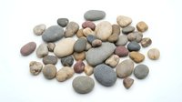 Collection of smooth river rocks and pebbles in natural earth tones isolated on white background for spa, zen meditation, crafts and decorative projects.