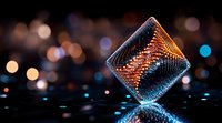 Glowing geometric cube with intricate orange and blue light patterns floating against dark background with bokeh lights, creating futuristic sci-fi atmosphere.