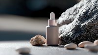Minimalist cosmetic dropper bottle against natural stone background with pebbles and rocks in soft lighting, creating zen spa atmosphere for skincare products.