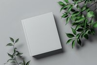 Blank white book cover mockup with green botanical leaves on neutral background for branding and publishing design projects.