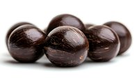 Dark chocolate covered macadamia nuts arranged in group on white background, showing rich brown coating with natural texture and glossy surface. Macro food photography.