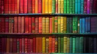 Colorful rainbow collection of vintage books arranged by color on wooden library shelves, perfect for education, literature and knowledge concepts, creating vibrant spectrum display.