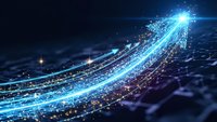 Glowing blue digital arrow with sparkling particles and light trails on dark background representing growth, progress and forward movement in technology.