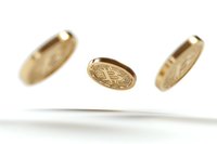 Golden bitcoin coins floating in air against white background, cryptocurrency concept with selective focus and motion blur effect.