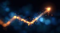 Glowing golden arrow path with sparkles and particles rising on dark blue background, representing growth, success and financial progress.