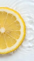 Fresh lemon slice floating in clear water with ripples and bubbles, bright citrus macro shot for food, beverage, and wellness design.