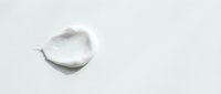 Creamy white cosmetic product sample isolated on light background, suitable for skincare, beauty, and wellness marketing materials.