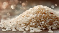 Heap of raw white rice grains with soft bokeh background, close-up view of uncooked jasmine or basmati rice for cooking and food preparation.