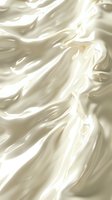Luxurious cream-colored silk fabric with soft folds and gentle waves creating an elegant flowing texture. Smooth satin material with pearl white highlights and shadows.