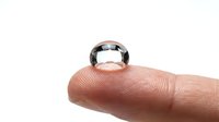 Water droplet resting on human fingertip against white background, isolated for design use on websites, presentations, and marketing materials.