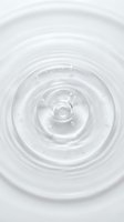 Concentric ripples and droplets in clear liquid create a serene, minimalist composition. Ideal for skincare, cosmetics, wellness, and beauty product marketing.