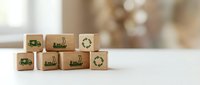 Wooden cubes with green eco-friendly transportation and recycling symbols on white surface. Sustainable logistics and environmental responsibility concept.
