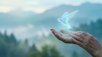 Open hand releasing glowing energy stream against mountain landscape backdrop for spiritual wellness and healing concepts.