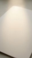 Blank white paper sheet with soft natural lighting and subtle shadows, isolated on neutral background for design mockups and branding projects.