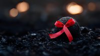 Black bath bomb with red satin bow on dark textured background with bokeh lights. Spa and wellness concept for aromatherapy and relaxation treatments.