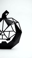 Black geometric sculpture with angular faceted design on white background for modern art and contemporary decor projects.