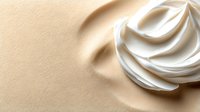 Luxurious white cream swirl on warm beige textured background with soft shadows, skincare cosmetic product for beauty and wellness applications.