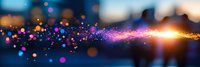 Magical glowing particles with purple and orange light trail floating on dark background, creating ethereal bokeh effect and cosmic atmosphere.