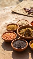 Traditional clay bowls filled with colorful spices and lentils arranged on rustic ground surface for authentic cooking and culinary preparation.
