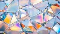 Iridescent crystal geometric pattern with holographic effect and light refraction creates abstract background with blue, orange and rainbow colors.