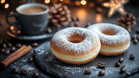 Fresh donuts dusted with powdered sugar served with hot coffee on dark background, scattered coffee beans and cinnamon sticks create cozy atmosphere.