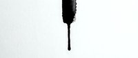 Black ink drop falling with splash effect isolated on white background for graphic design and artistic projects.