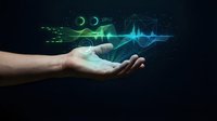Open palm hand holding glowing green and blue digital sound waves, moon phases, and tech particles on dark background for audio technology concepts.