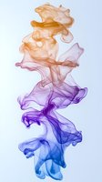 Ethereal flowing smoke in gradient colors from orange to purple and blue creates an abstract artistic composition against white background for creative designs.
